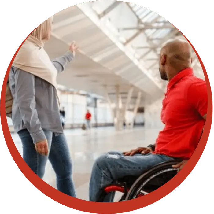 Muslim support worker with disabled man in wheelchair