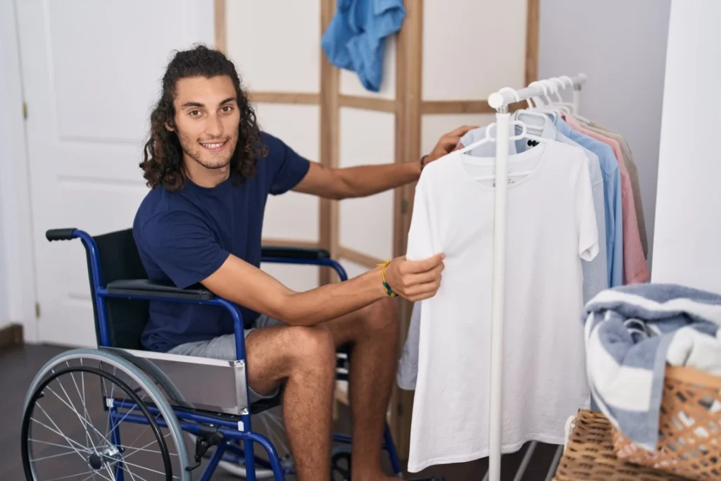 Disabled man in wheelchair choosing what to wear