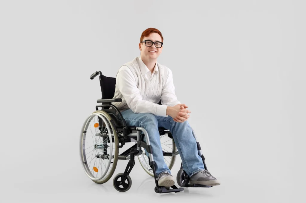 Happy disabled man in wheelchair smiling at camera